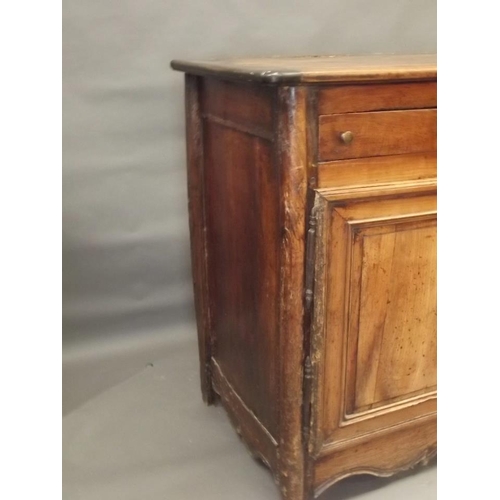 864 - An early C20th French fruitwood buffet with three drawers over two panelled doors, with a shaped car... 