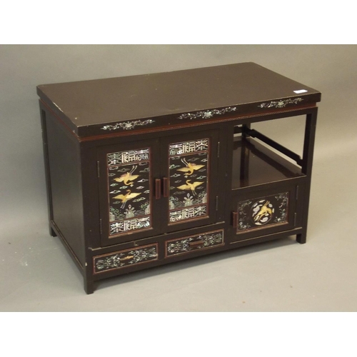 865 - A Chinese black lacquer cabinet with finely inlaid mother of pearl and abalone decoration of storks ... 