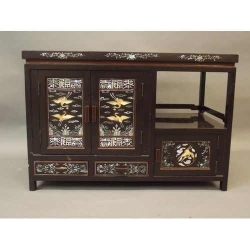 865 - A Chinese black lacquer cabinet with finely inlaid mother of pearl and abalone decoration of storks ... 