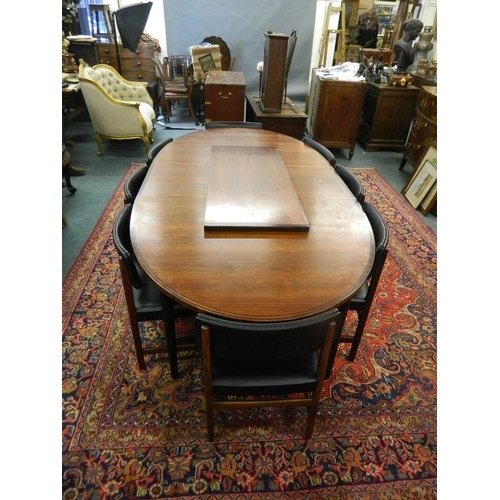 881 - An Archie Shine Indian rosewood oval shaped dining table with two extra leaves, and a set of eight c... 