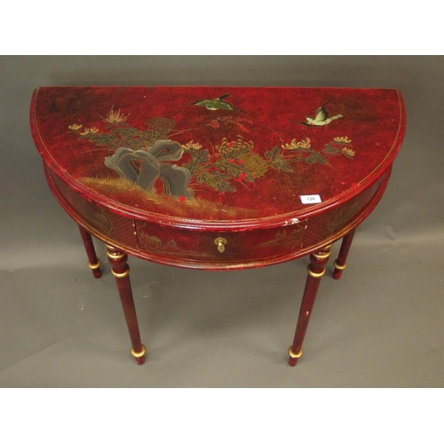 886 - A Chinese red lacquer single drawer demi line side table with gilt chinoiserie decoration, raised on... 