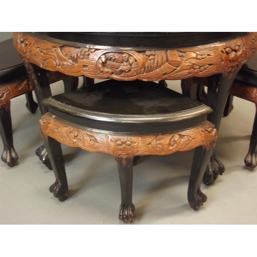 887 - A mid C20th Chinese tea table and matching four stools, with carved decoration, the top with painted... 