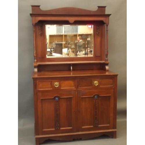 890 - An Arts & Crafts walnut dresser with mirror backed top and carved rose decoration, the base with two... 