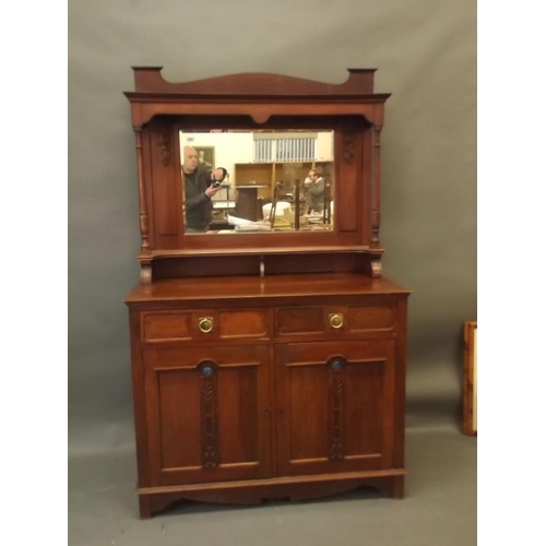 890 - An Arts & Crafts walnut dresser with mirror backed top and carved rose decoration, the base with two... 