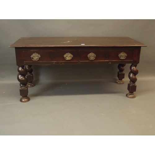 892 - A C19th Anglo-Indian hardwood two drawer side table with brass handles, raised on carved twisted sup... 