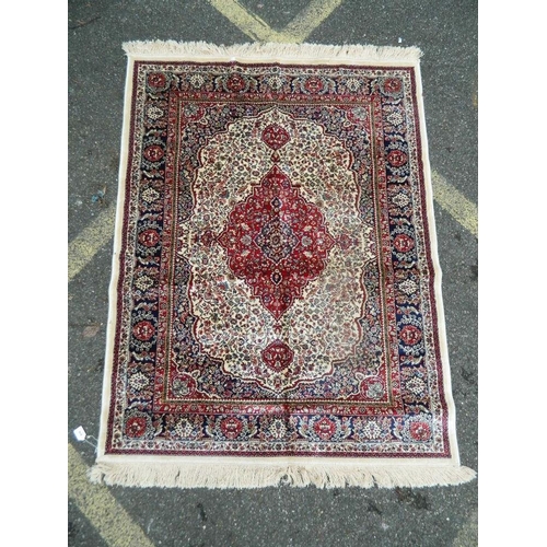 895 - An ivory ground Kashmir rug with traditional medallion design, 46