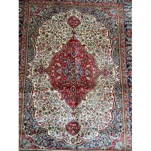 895 - An ivory ground Kashmir rug with traditional medallion design, 46