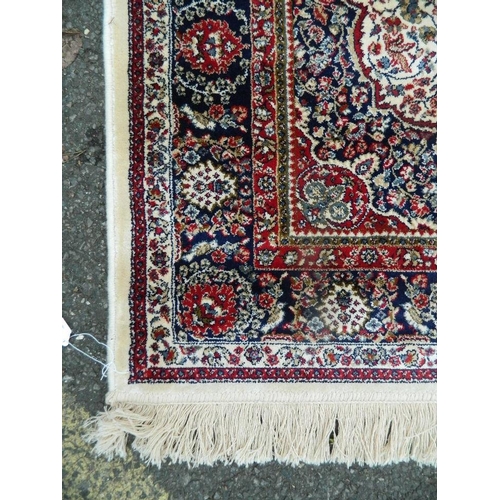 895 - An ivory ground Kashmir rug with traditional medallion design, 46