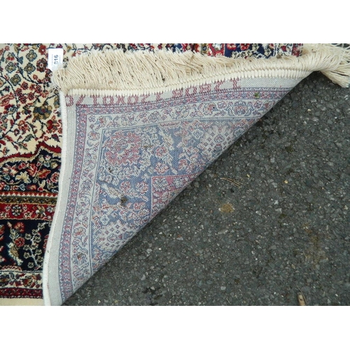 895 - An ivory ground Kashmir rug with traditional medallion design, 46