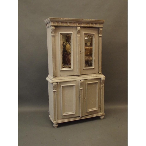 900 - A small C19th Continental painted pine cabinet of two cupboards with mirrored panels over two more, ... 