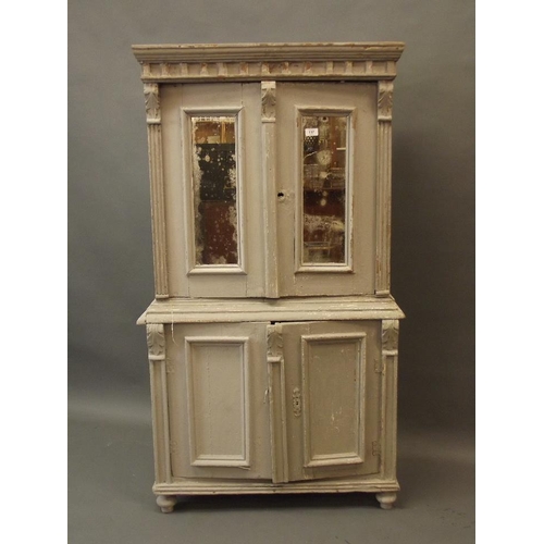 900 - A small C19th Continental painted pine cabinet of two cupboards with mirrored panels over two more, ... 