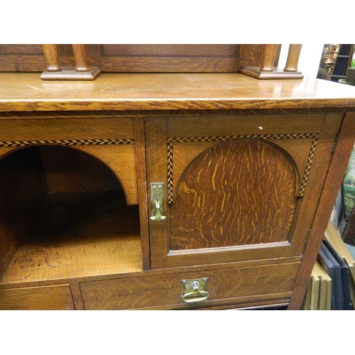 905 - An Arts & Crafts inlaid oak dresser, the dome topped upper section and shelf supported by columns ov... 