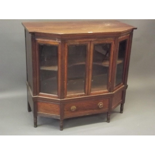 906 - A Victorian rosewood shaped front cabinet with two glazed doors over a single drawer, raised on turn... 