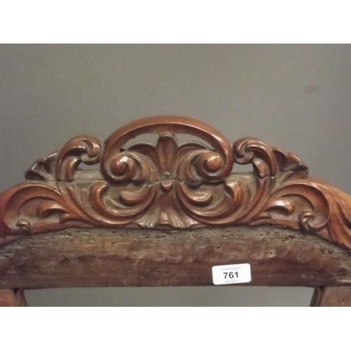 913 - An early Victorian rosewood nursing chair with carved and pierced crest back, raised on carved cabri... 