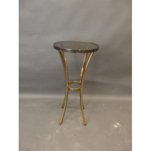 921 - A contemporary brass and tinted glass jardiniere stand, raised on sabre supports, 14