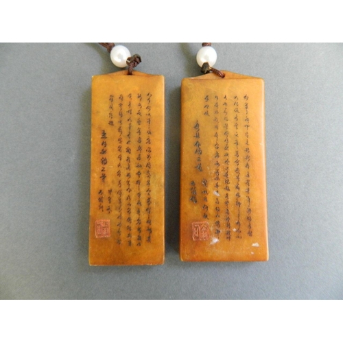 99 - A Chinese amber soapstone seal with engraved landscape decoration, and another similar, 3