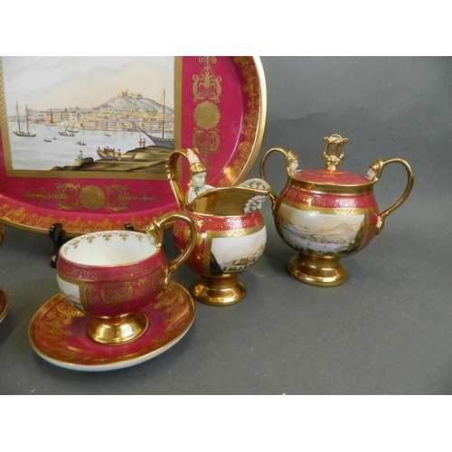 104 - A Berlin style pink ground porcelain tea set for two with gilt highlights, decorated with masks and ... 