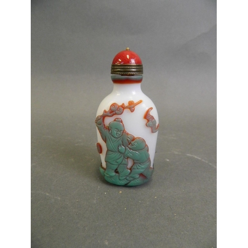 115 - A Chinese moulded resin snuff bottle decorated with boys playing, 3