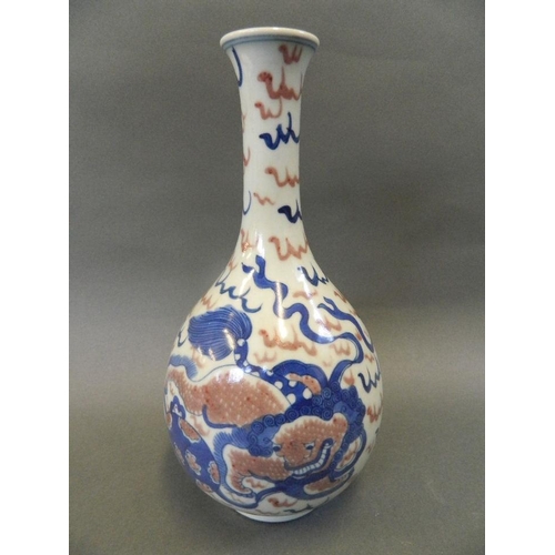 119 - A Chinese blue and white porcelain slender necked bottle vase with bulbous base, decorated with kyli... 