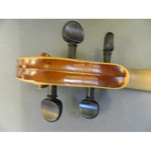 122 - An Italian violin with two piece back, bears label inside, together with a bow and wooden case, 23