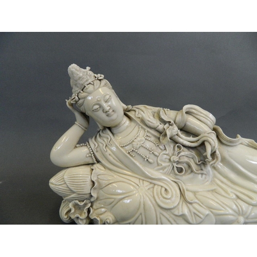 129 - A large Chinese Blanc de Chine figure of Quan Yin reclining on a lotus, seal mark verso, 16