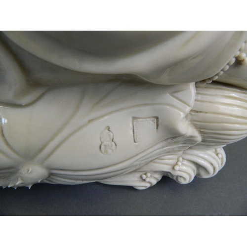 129 - A large Chinese Blanc de Chine figure of Quan Yin reclining on a lotus, seal mark verso, 16