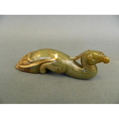 138 - A Chinese green jade pen rest carved in the form of a phoenix with gilt inlaid decoration, 4½