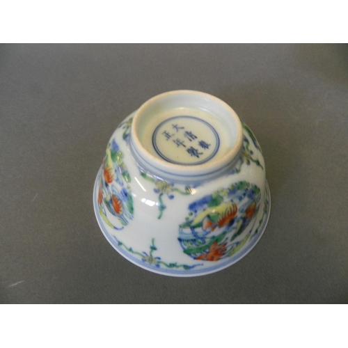 149 - A Chinese Doucai porcelain rice bowl decorated with waterfowl by a pond in bright enamels, 6 charact... 