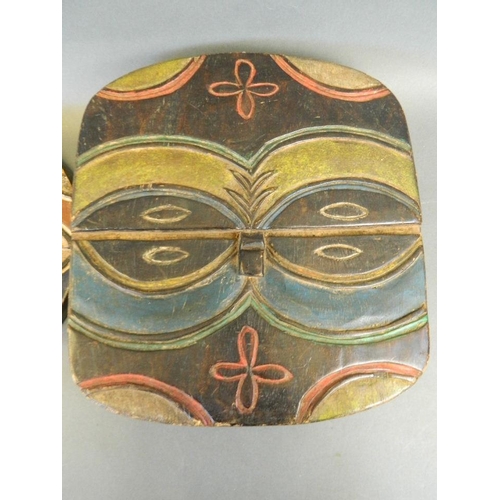 150 - An African circular wood mask with oval eyes and painted highlights, Democratic Republic of Congo Te... 