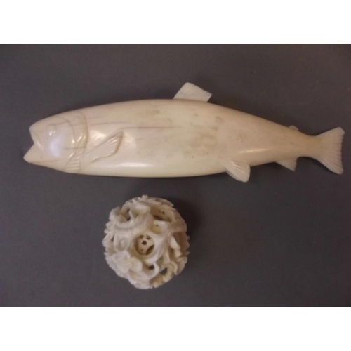 150X - A carved ivory figure of a salmon, together with a small carved ivory puzzle ball, 6