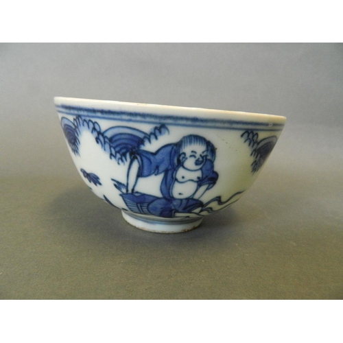 155 - A Chinese blue and white porcelain rice bowl decorated with figures relaxing in a garden, 6 characte... 