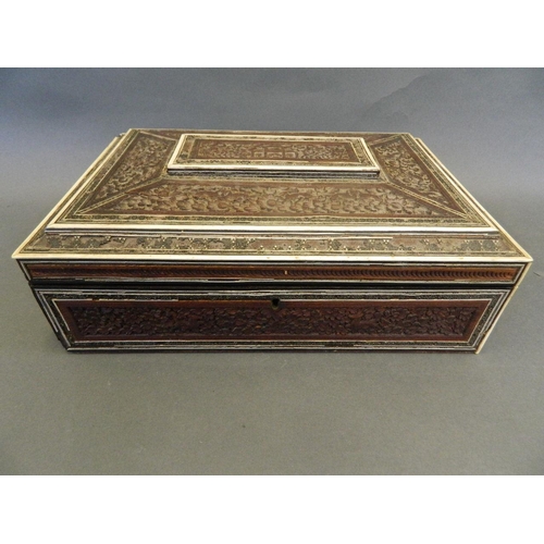 166 - An Indian bone inlaid carved sandlewood sewing box with fitted interior and brass handles, with ivor... 