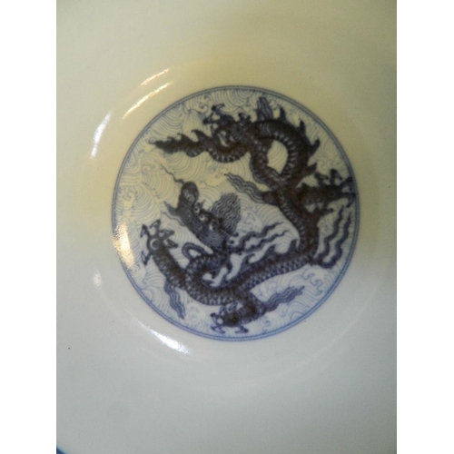 17 - A Chinese blue and white porcelain bowl decorated with dragons amongst clouds, 6 character mark to b... 