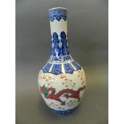 177 - A Chinese blue and white porcelain bottle vase decorated with green and red dragons amongst yellow c... 