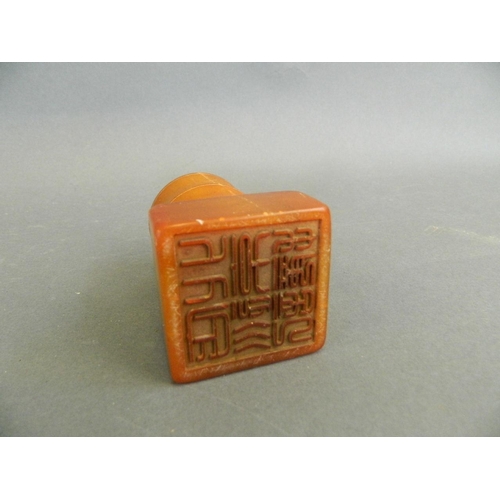 184 - A Chinese amber soapstone seal with shaped handle in the form of bamboo, 3