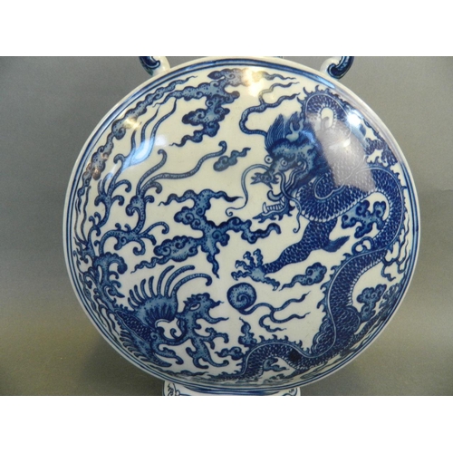 194 - A Chinese blue and white porcelain moonflask with twin elephant head handles and dragon and phoenix ... 