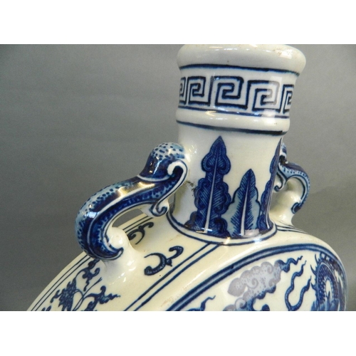 194 - A Chinese blue and white porcelain moonflask with twin elephant head handles and dragon and phoenix ... 