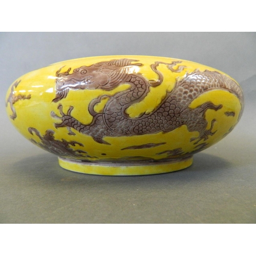 195 - A Chinese yellow ground porcelain bowl with incised brown enamelled dragon decoration, 6 character m... 