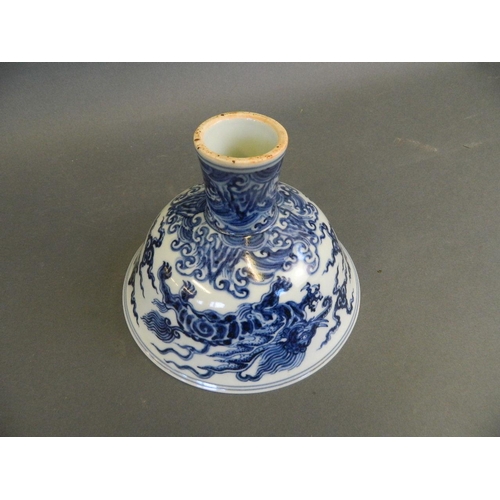 196 - A Chinese Ming style blue and white porcelain stem bowl with painted decoration of winged mythical c... 