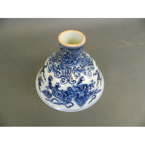 196 - A Chinese Ming style blue and white porcelain stem bowl with painted decoration of winged mythical c... 