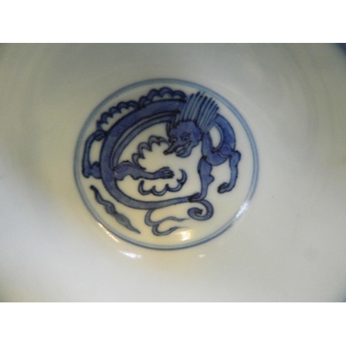 207 - A Chinese blue and white porcelain rice bowl decorated with mythical beasts, 4 character mark to bas... 