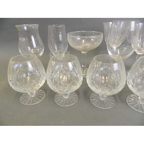 21 - An assorted collection of drinking glasses to include brandy balloons, flutes, goblets etc