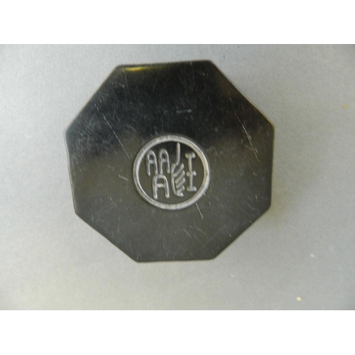 28 - A Chinese black soapstone octagonal box with carved Quan Yin decoration to lid, containing an amber ... 