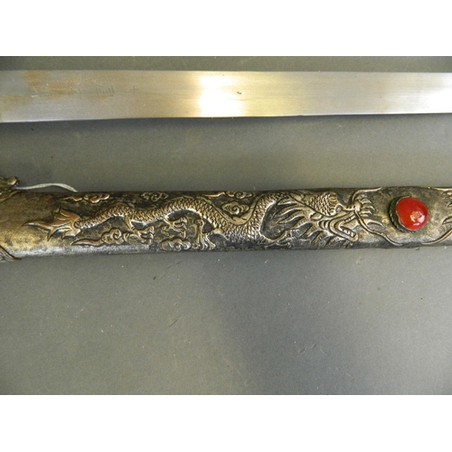 32 - A Chinese Jian sword with silvered metal scabbard and hilt, the blade with repoussé dragon decoratio... 