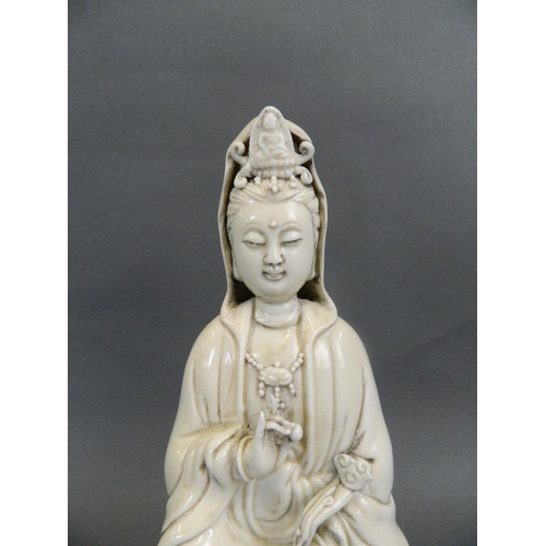 4 - A Chinese Blanc de Chine figure of Quan Yin seated on a lotus throne, seal mark verso, 11