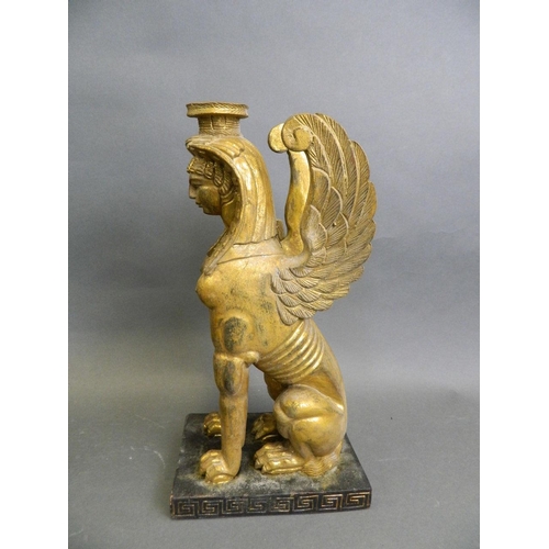 46 - A pair of Egyptian carved gilt wood candlesticks in the form of sphinx, 12