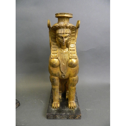 46 - A pair of Egyptian carved gilt wood candlesticks in the form of sphinx, 12