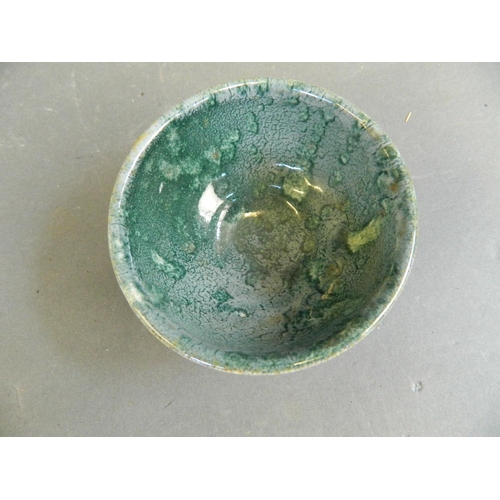 50F - An Oriental studio pottery tea bowl with bi-colour glaze, seal mark to base, 3½