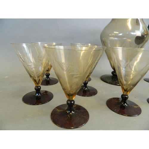 50Q - A set of nine engraved conical glasses on knop stems with brown feet, together with a matching bulbo... 