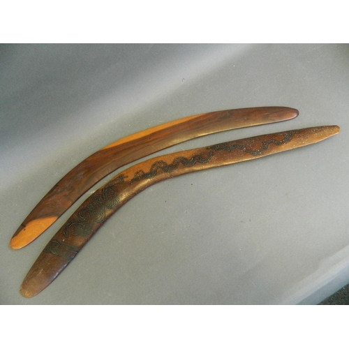 50U - A hardwood boomerang with engraved decoration of snakes and bush, and another, 27